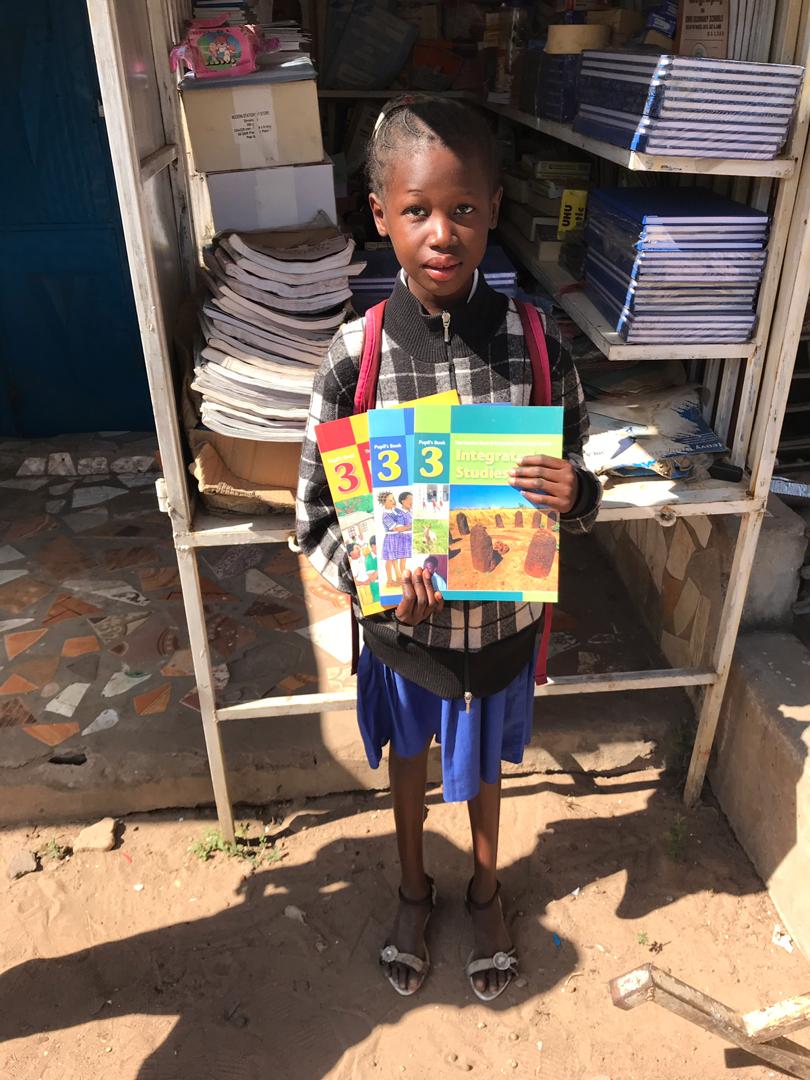 Young Gambian Girl holding workbooks