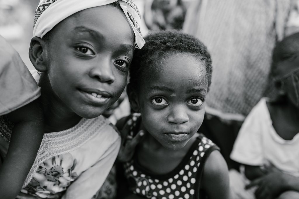 Black and White African children from Gambia seeking education to empower girls education