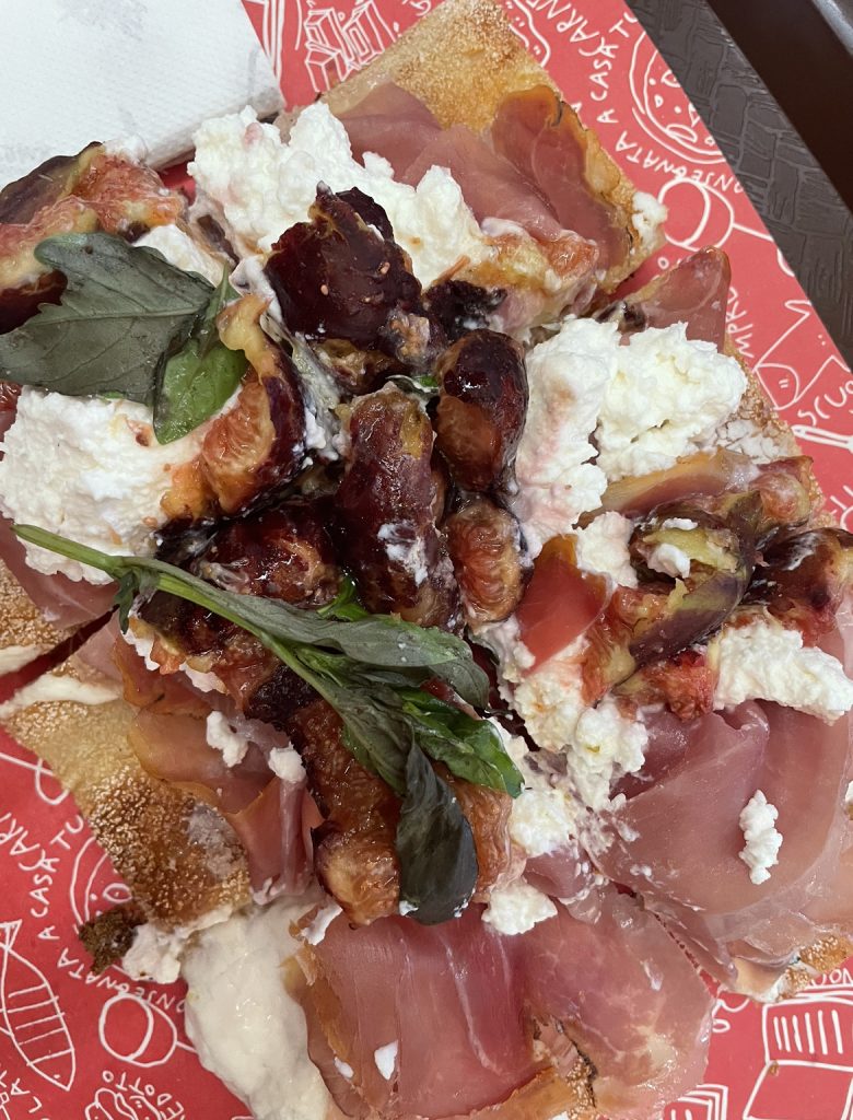 pizza with eggplant, proscuitto, cheese, and basil