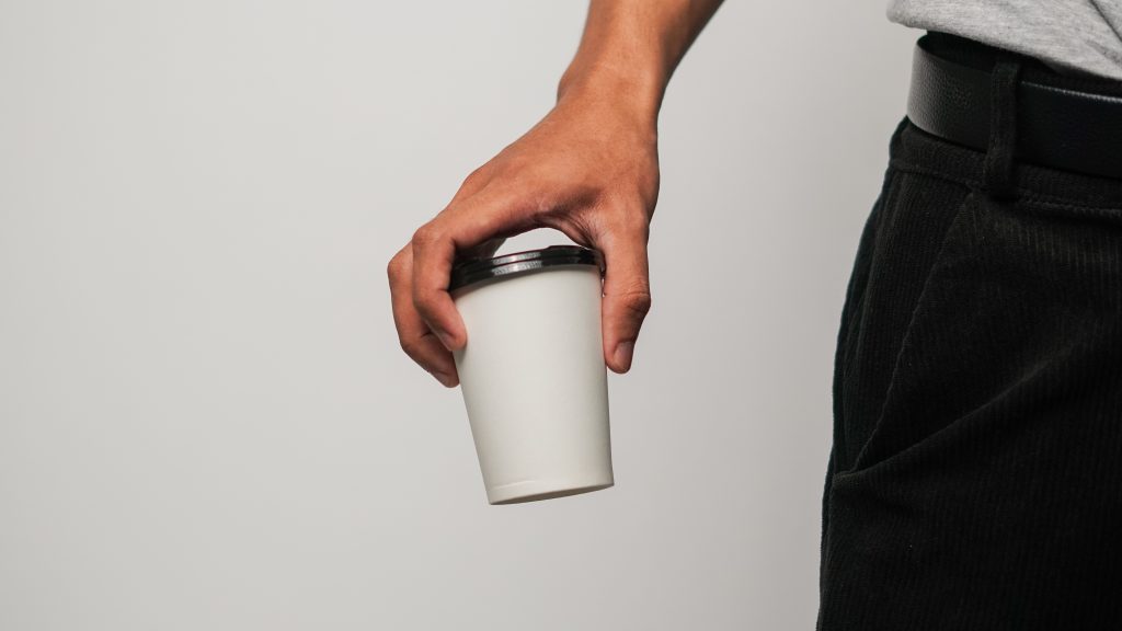 man holding a coffe cup
