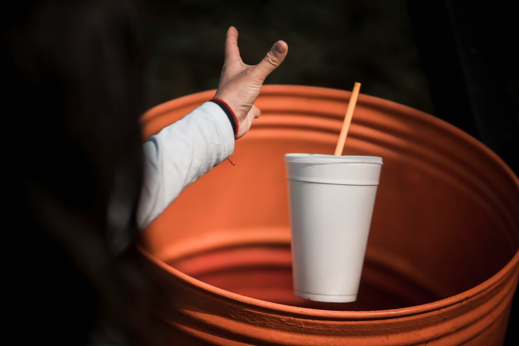 Person throwing cup in bin